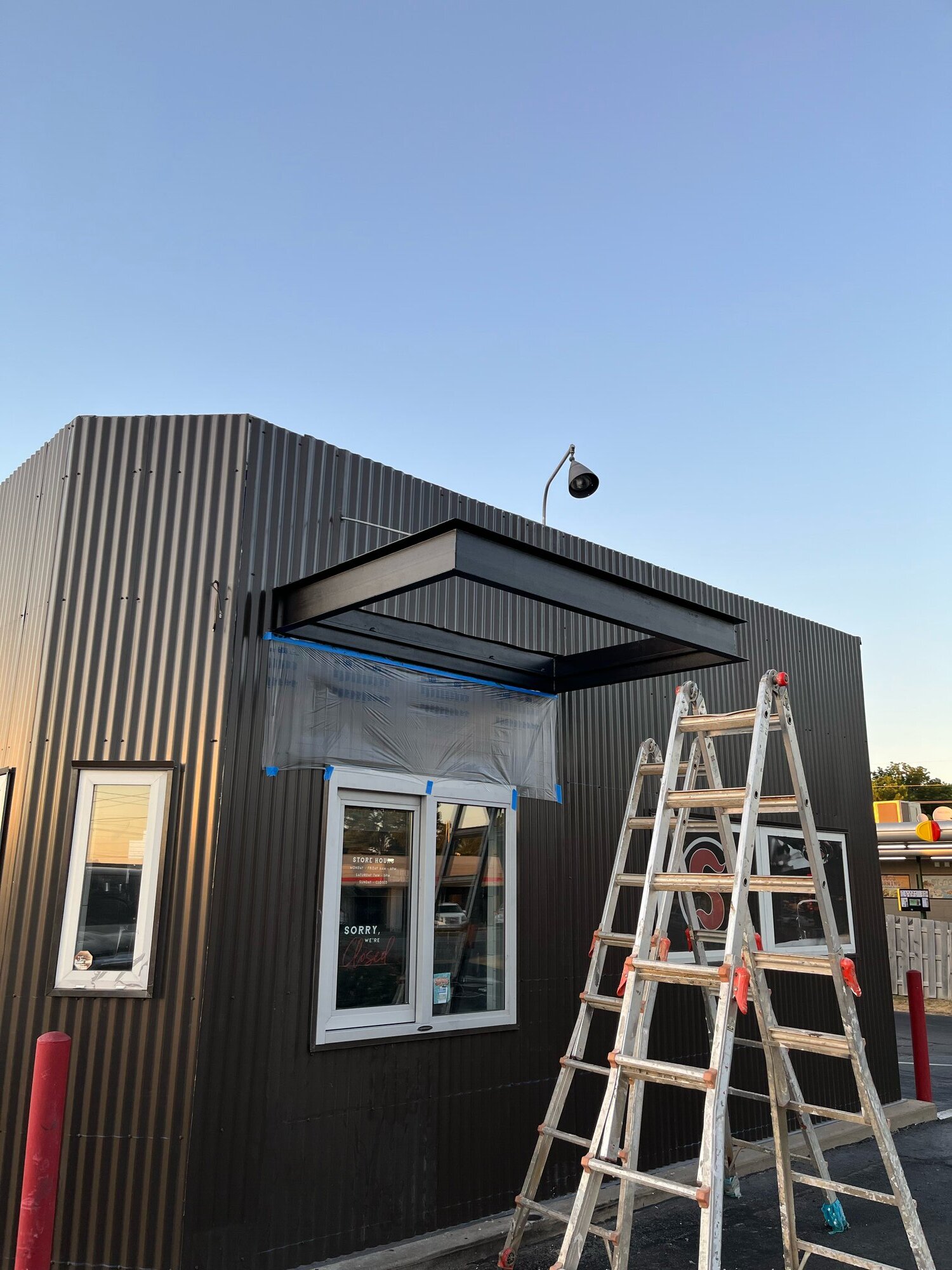 Commercial storefront with black metal siding